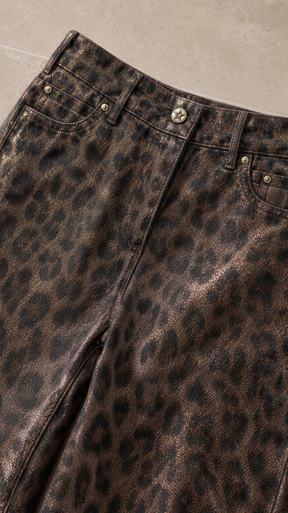 Close-up detail of Bronze Brown leopard print waistband, metal button, and pocket rivets