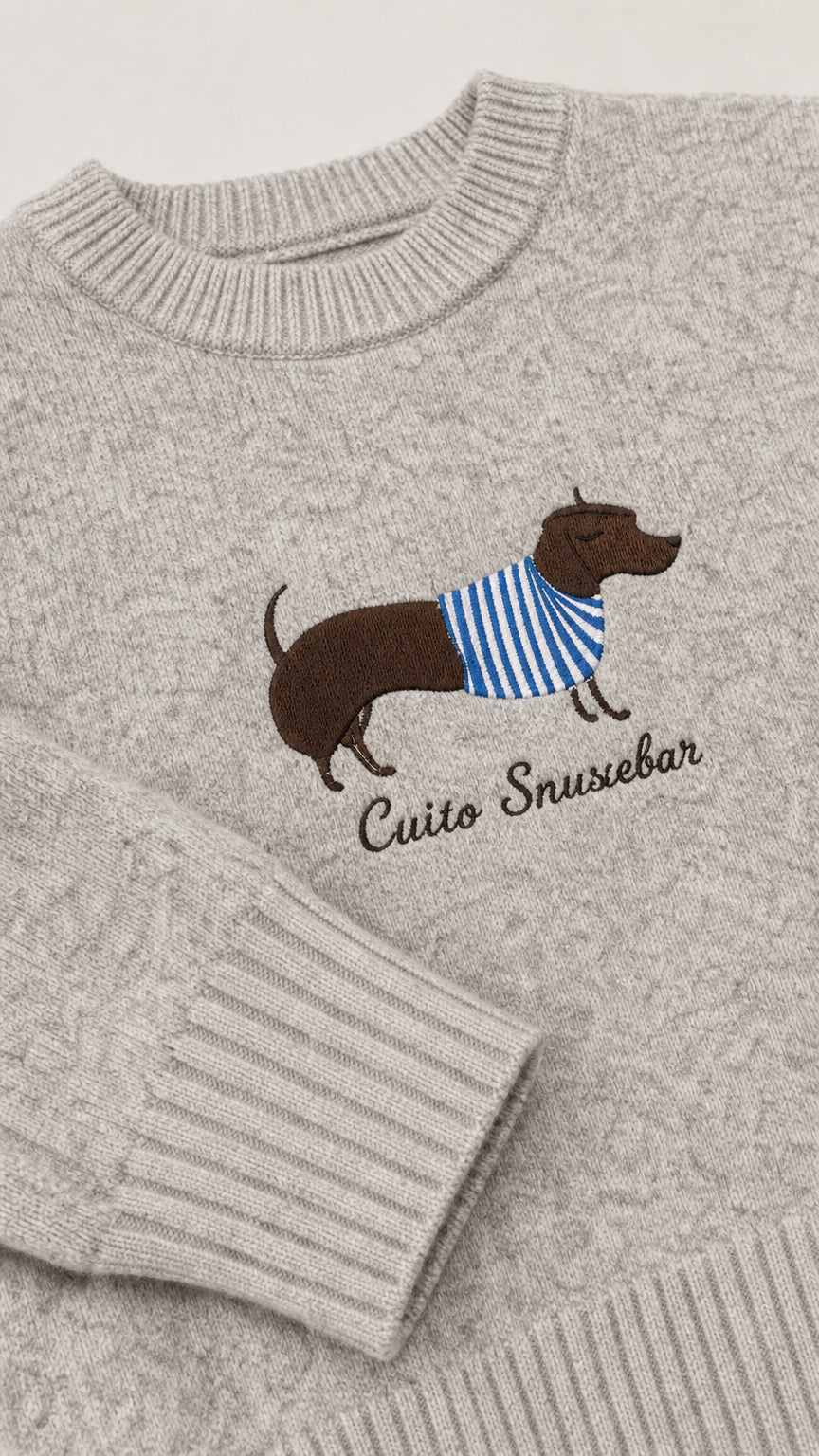 Close-up detail of embroidered dachshund dog wearing striped sweater on Heather Grey knit fabric