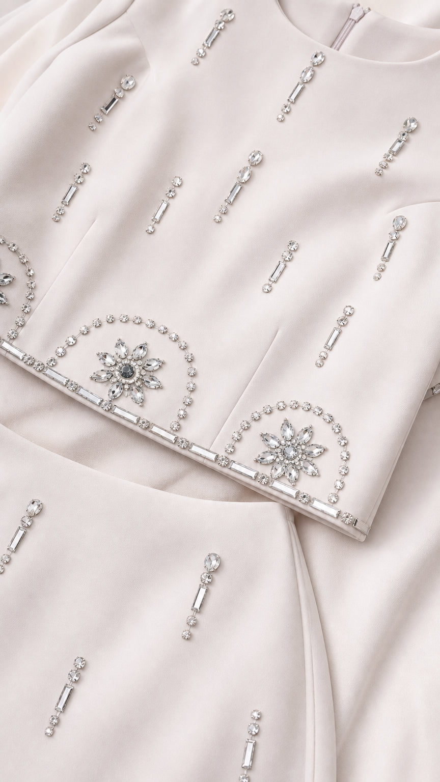 Close-up detail of sparkling crystal and rhinestone embellishments on the fabric