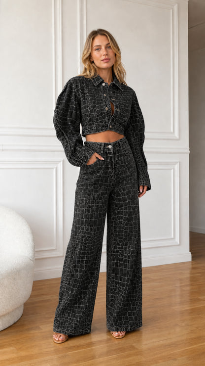 Model wearing washed black crocodile embossed cropped denim jacket and matching wide leg pants