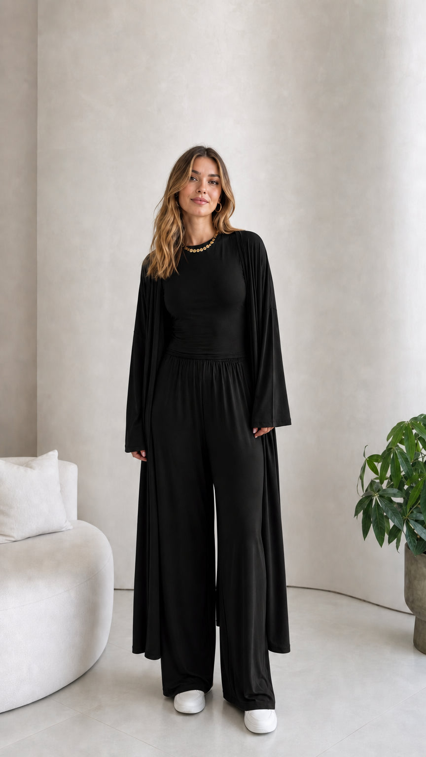 Front view of model wearing the 3-piece duster cardigan and pants set in black