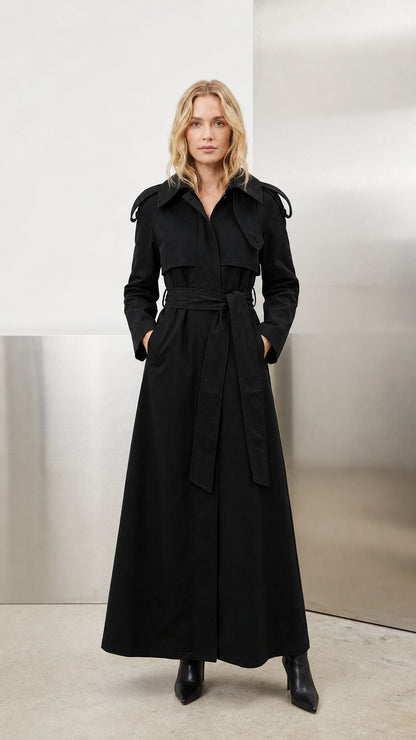 Model wearing classic black full-length belted maxi trench coat