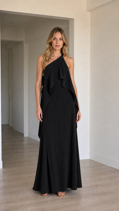 Front view of model wearing the one-shoulder cascading ruffle maxi dress in black