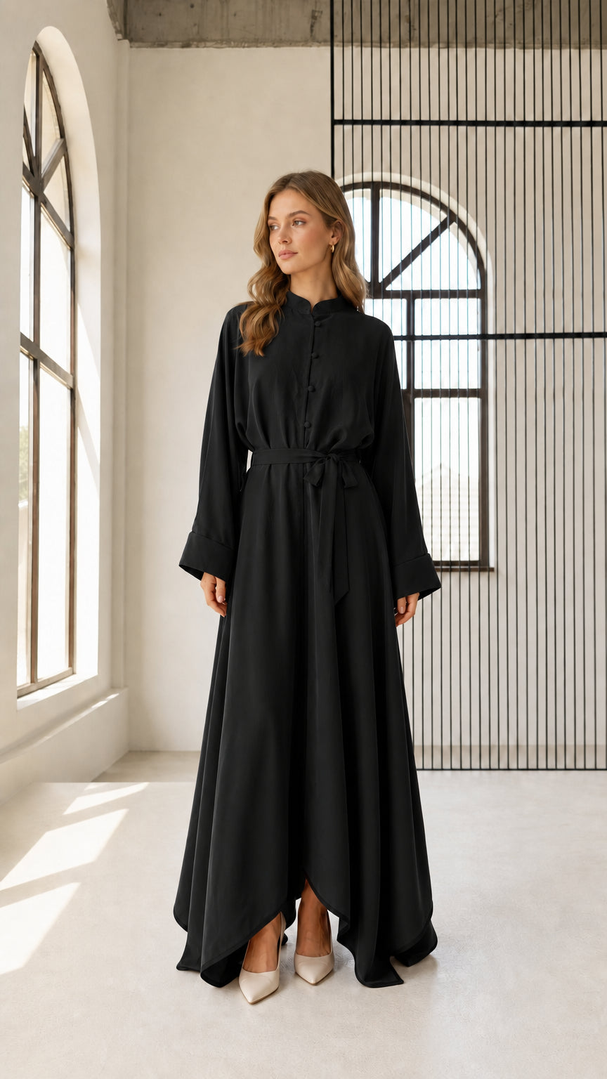 Front view of woman wearing black long sleeve belted maxi dress