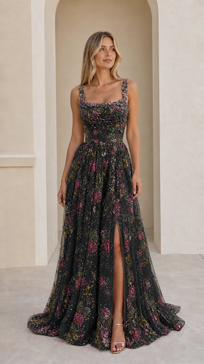 Front view of black floral embroidered sequin maxi formal gown with leg slit