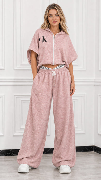 Model wearing dusty pink short sleeve cropped zip hoodie and matching wide leg sweatpants