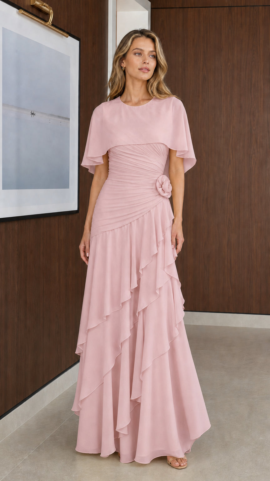 Model wearing Blush Pink capelet tiered ruffle evening gown
