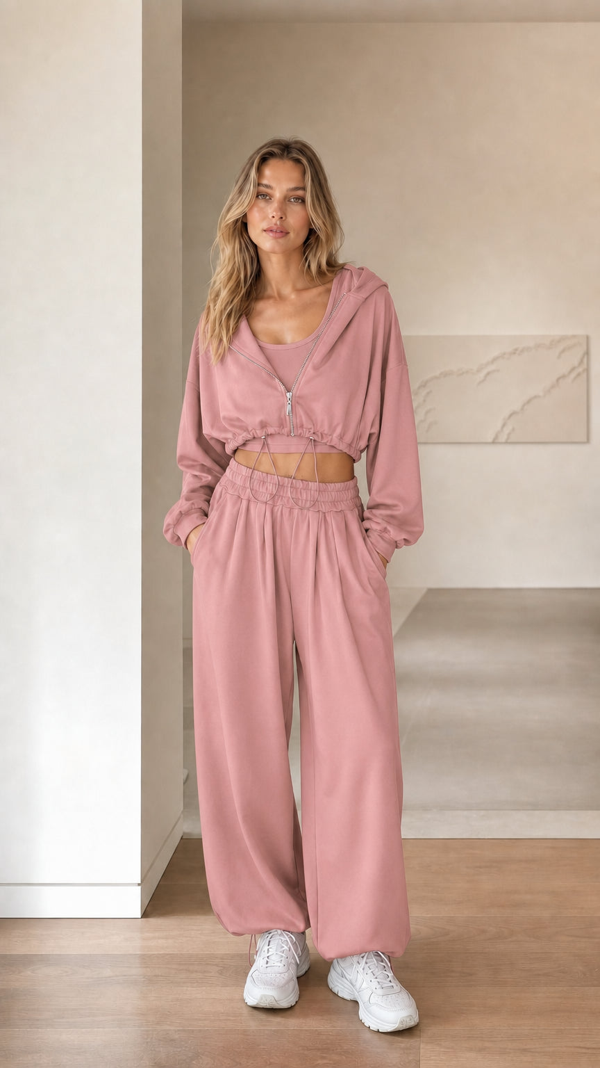 Front view of woman wearing dusty pink 3-piece cropped hoodie and sweatpants set