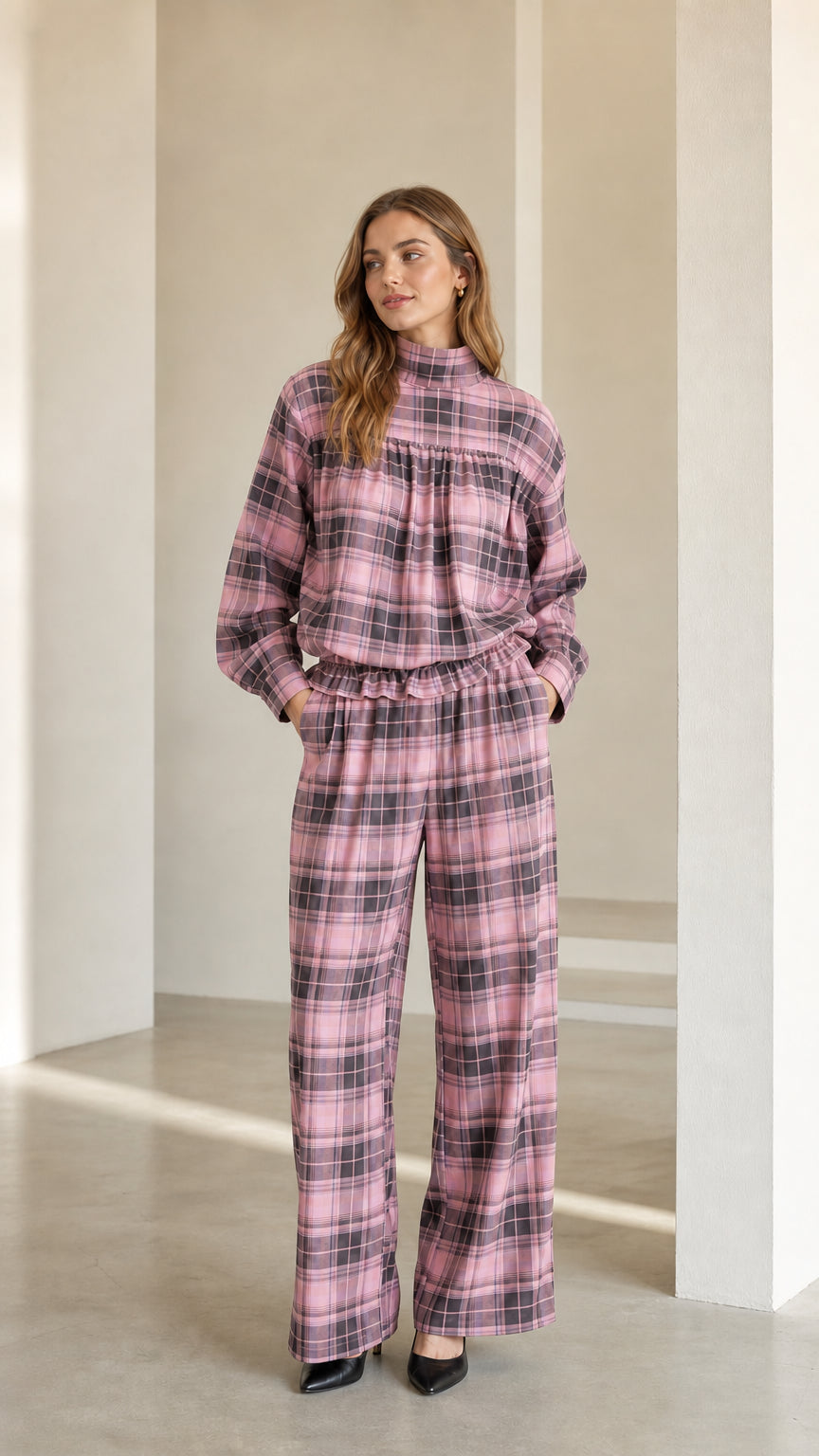 Model wearing dusty pink plaid mock neck top and relaxed wide leg pants set