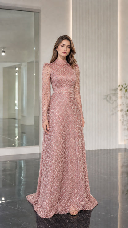 Model wearing blush pink embellished floor length gown with long sleeves