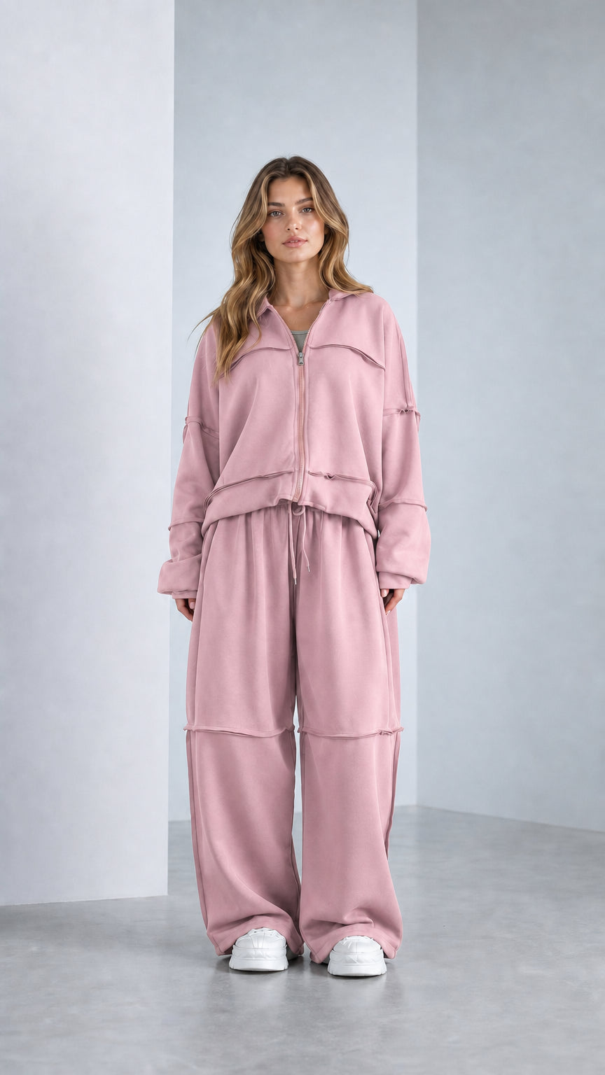 Full-length studio shot of model wearing Dusty Pink exposed seam sweatpants set
