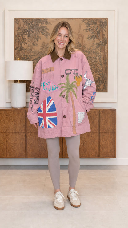 Model wearing dusty pink vintage graphic chore coat with brown corduroy collar