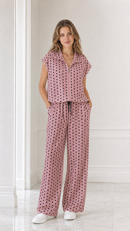 Model wearing dusty rose pink polka dot two-piece set with wide leg pants