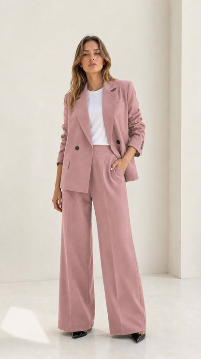 Woman wearing elegant dusty pink tailored blazer and wide-leg pant suit set