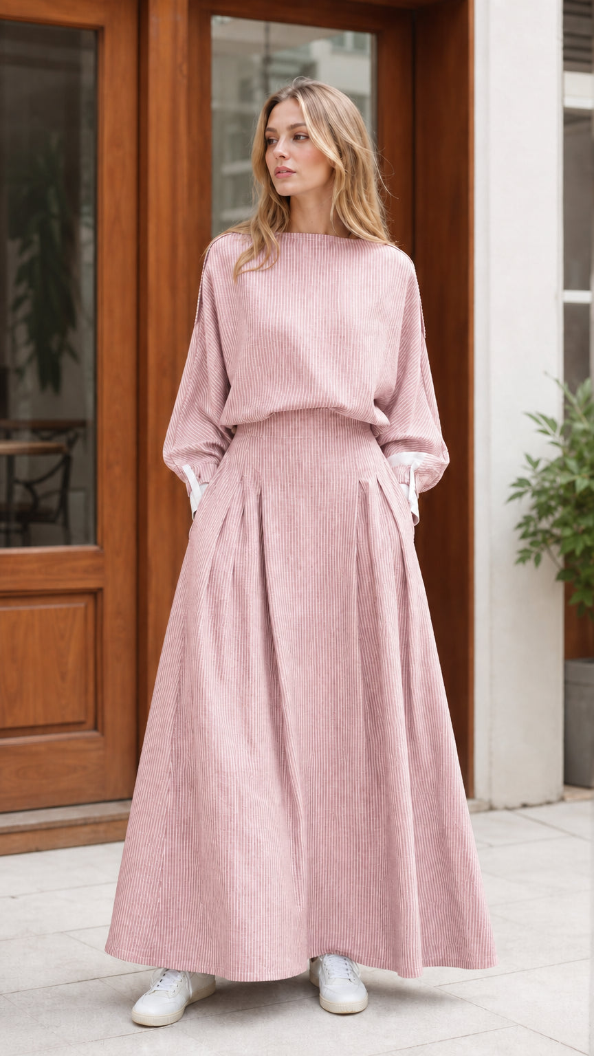 Model wearing dusty pink striped pleated maxi dress with contrast cuffs