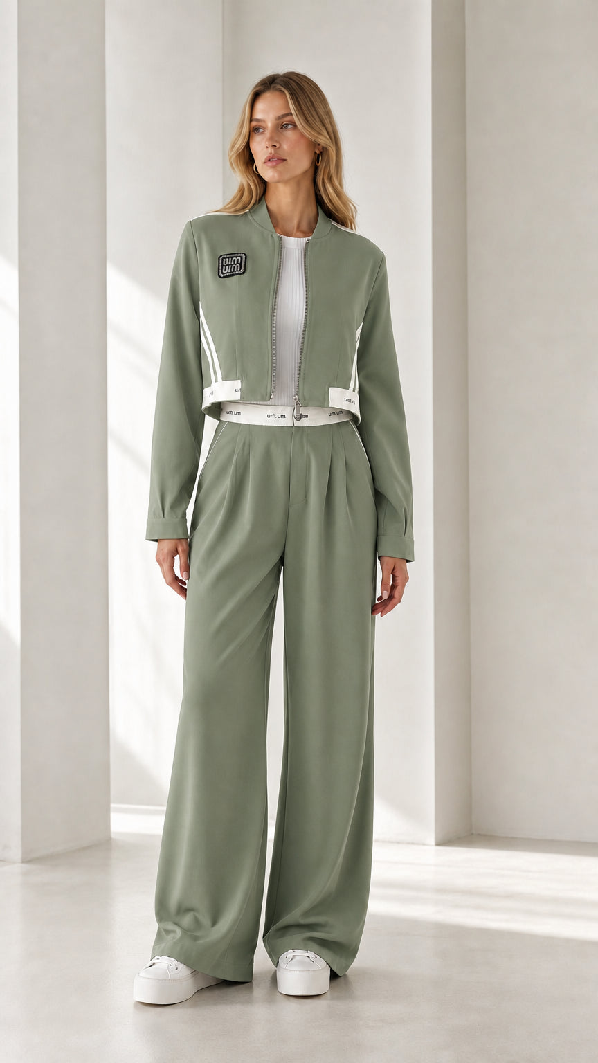 Full view of model wearing sage green cropped jacket and wide-leg pants set