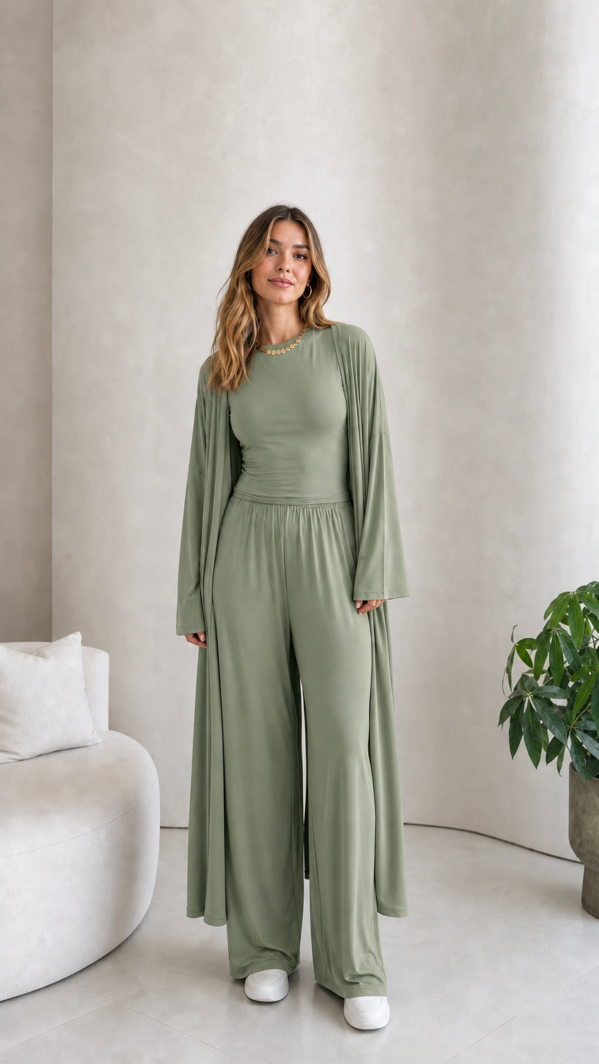 Front view of model wearing the 3-piece duster cardigan and pants set in sage green