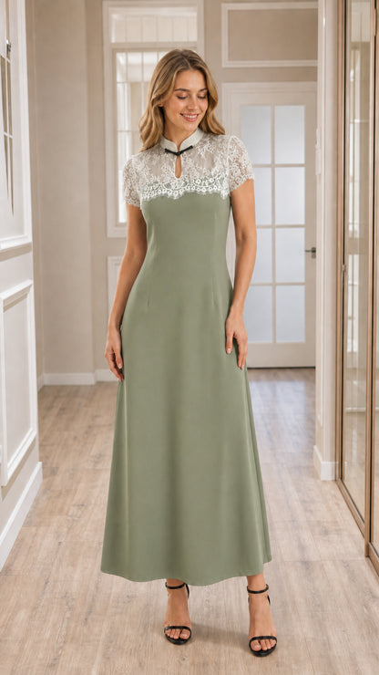 Front view of model wearing sage green lace yoke A-line maxi dress