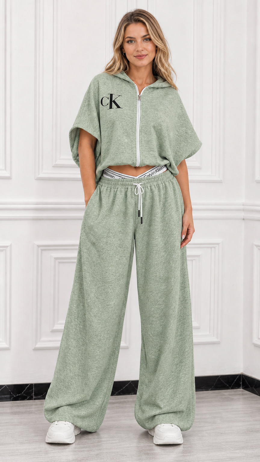 Model wearing sage green short sleeve cropped zip up hoodie and matching wide leg pants