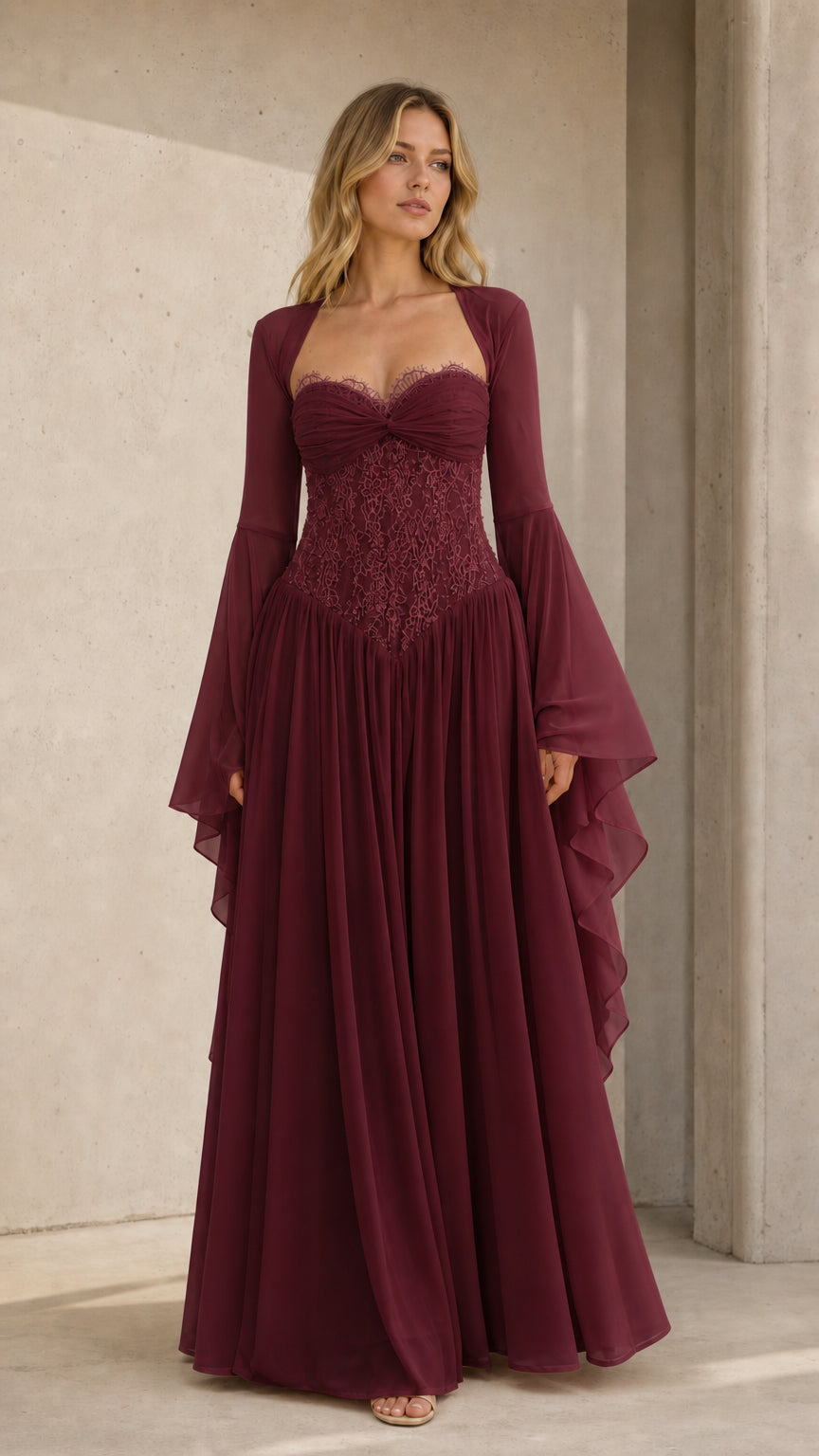 Front view of model wearing burgundy wine lace corset formal evening gown
