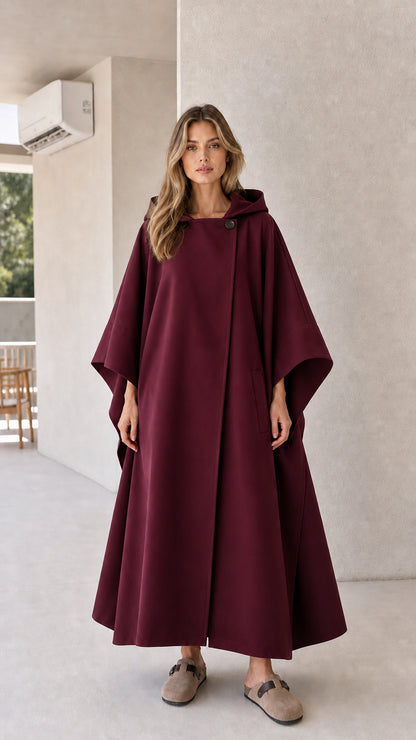 Model wearing burgundy wine red hooded cape coat