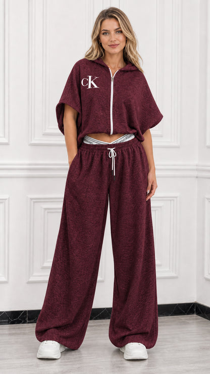 Model wearing burgundy short sleeve cropped hoodie and matching wide leg lounge pants