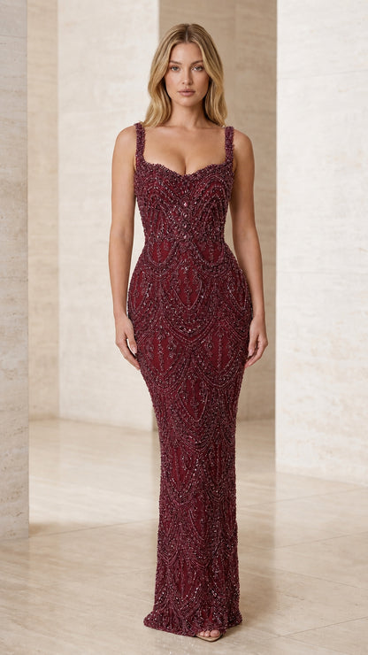 Model wearing Burgundy red embellished sleeveless evening gown