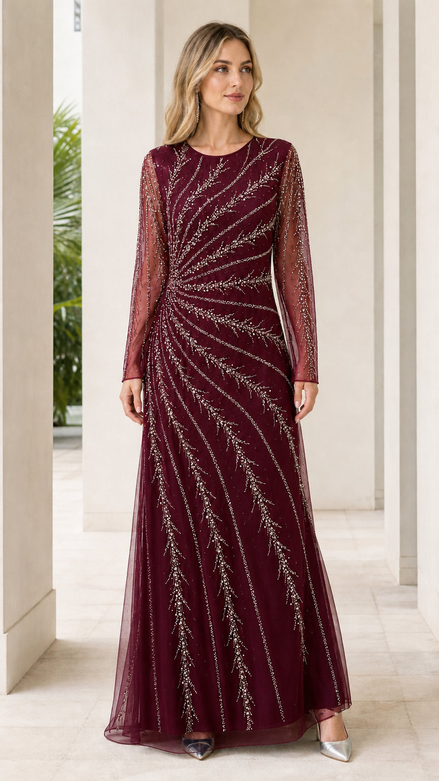 Woman wearing burgundy wine long sleeve beaded formal gown