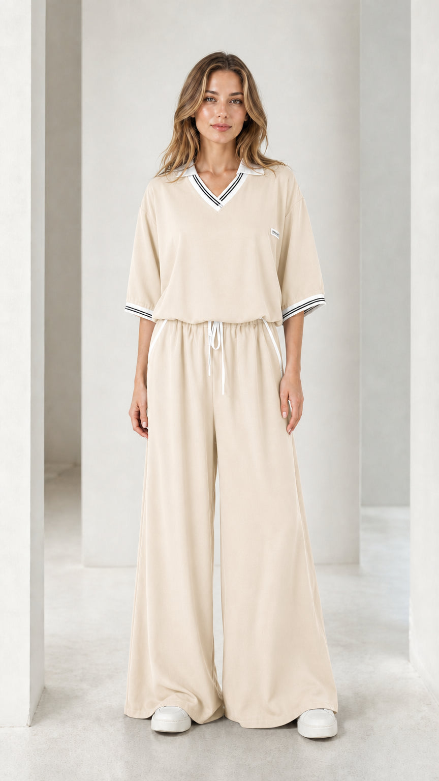 Front view of a cream women's wide-leg jumpsuit with striped collar and cuffs