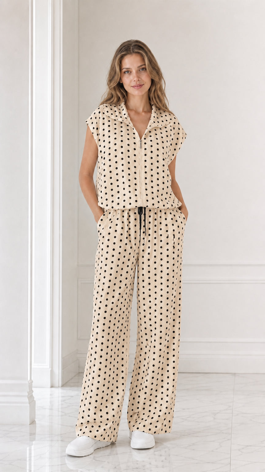 Model wearing beige cream polka dot two-piece set with wide leg pants